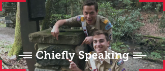 The National Chief Zach Schonfeld and National Vice Chief Noah Smith pointing to a rock with "Quapaw Little Rock, AR". The overlying text says chiefly speaking.