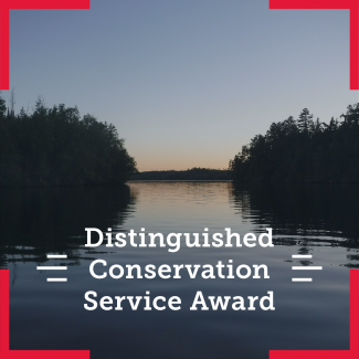 Scenic view of water and trees. The overlying text says Distingished Conservation Service Award